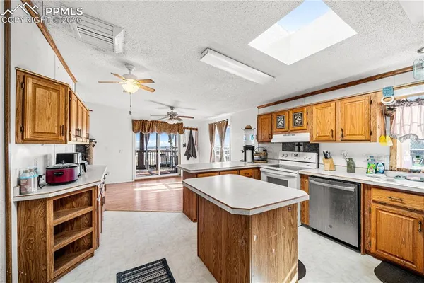 a kitchen with stainless steel appliances granite countertop a sink stove and cabinets