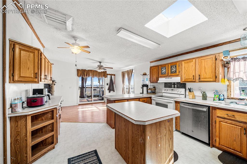 8435 Savage Road Beulah, CO 81023 - Photo 5 of 34 a kitchen with stainless steel appliances granite countertop a sink stove and cabinets
