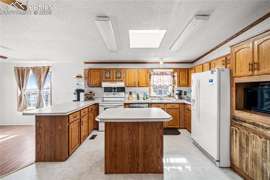 8435 Savage Road Beulah, CO 81023 - Photo 6 of 34 a kitchen with stainless steel appliances a sink stove and refrigerator