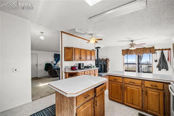 a kitchen with a stove a sink dishwasher and a refrigerator with wooden floor