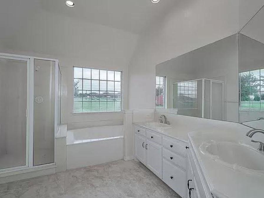 1191 Pasewark Circle Prosper, TX 75078 - Photo 14 of 20 a bathroom with a granite countertop sink mirror bathtub and shower