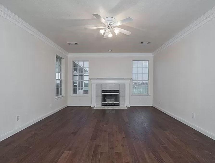 1191 Pasewark Circle Prosper, TX 75078 - Photo 15 of 20 a view of an empty room with wooden floor fireplace and a window