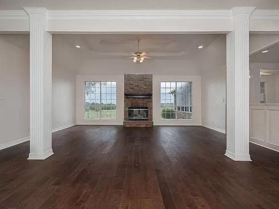 1191 Pasewark Circle Prosper, TX 75078 - Photo 8 of 20 an empty room with wooden floor fireplace and windows