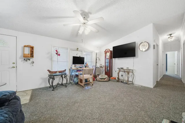 a view of a livingroom with furniture and a flat screen tv