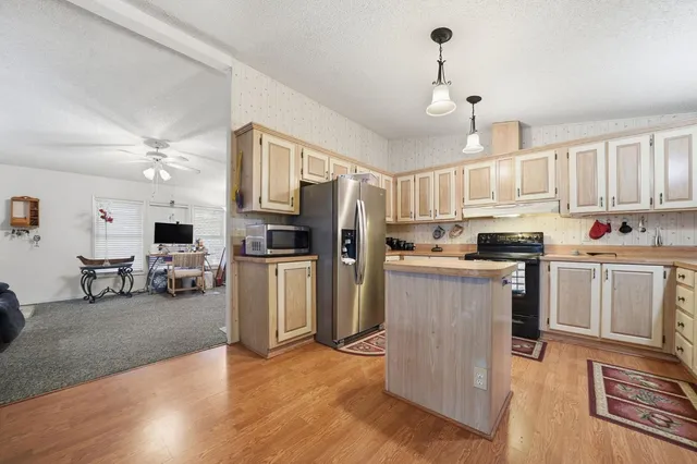a kitchen with refrigerator and cabinets