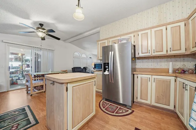 a kitchen with stainless steel appliances granite countertop a refrigerator a stove and a sink with granite countertops