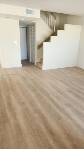 an empty room with wooden floor