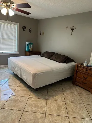 a bedroom with a bed and a lamp