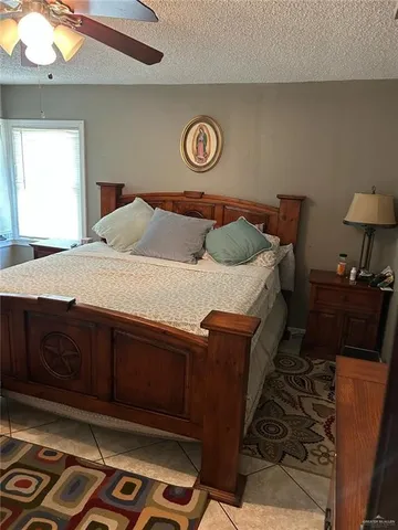 a spacious bedroom with a bed and a mirror