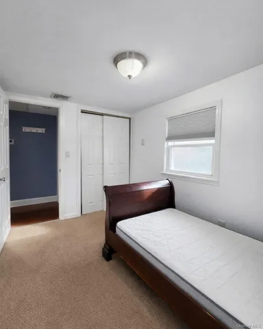 a bedroom with a bed and window