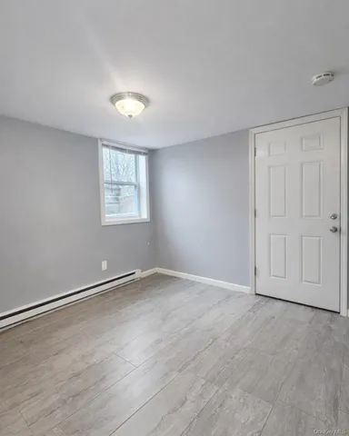 an empty room with windows and closet