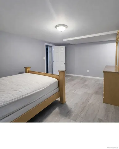 a bedroom with a bed and a night stand