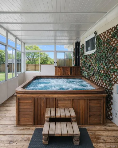 a kitchen with kitchen island a large window and cabinets