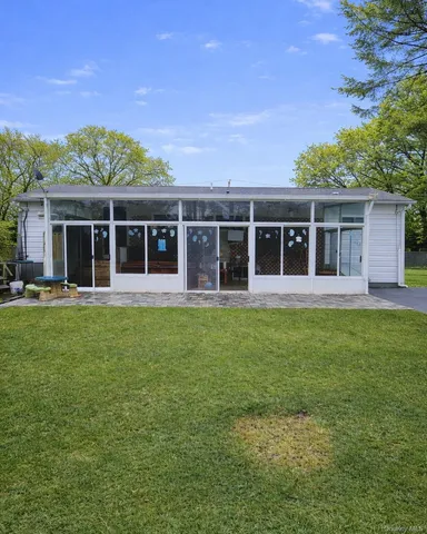 a view of a house with a backyard