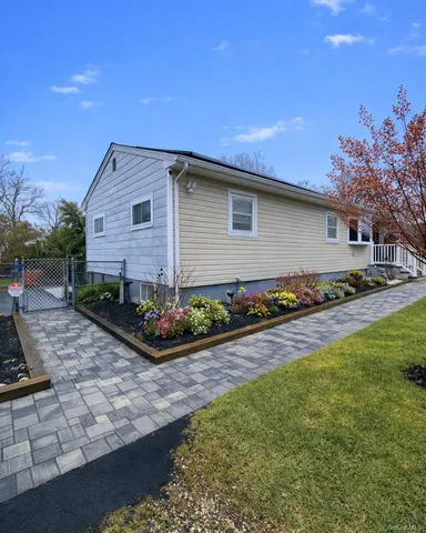 a front view of a house with yard and potted plants