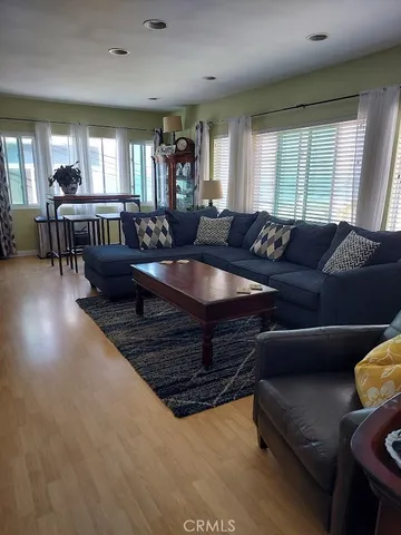 a living room with furniture and wooden floors