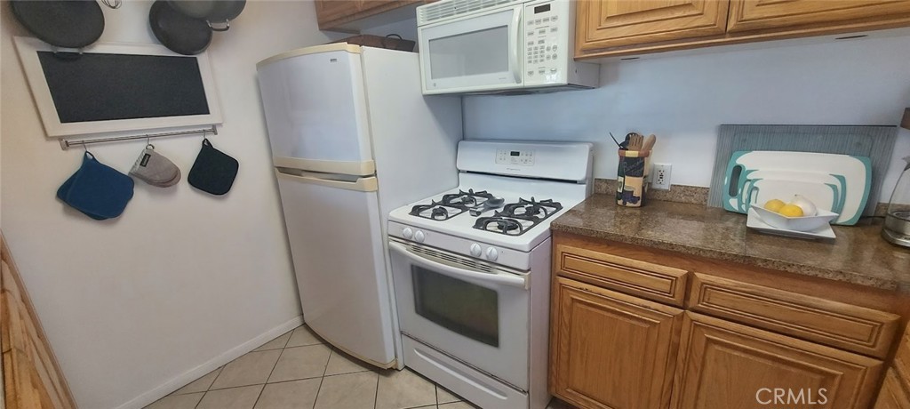 204 45th Street, Unit UPPR Manhattan Beach, CA 90266 - Photo 2 of 7 a kitchen with stainless steel appliances granite countertop a refrigerator and a stove