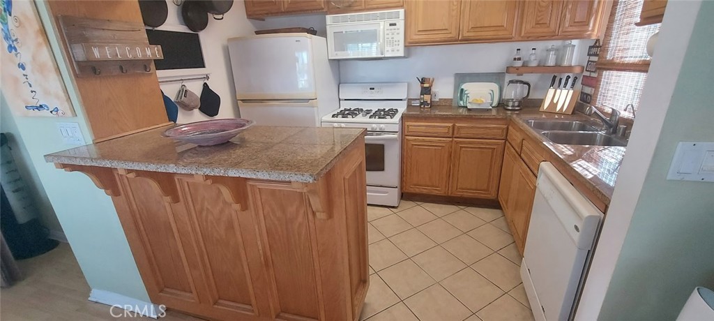 204 45th Street, Unit UPPR Manhattan Beach, CA 90266 - Photo 3 of 7 a kitchen with a sink a stove and cabinets