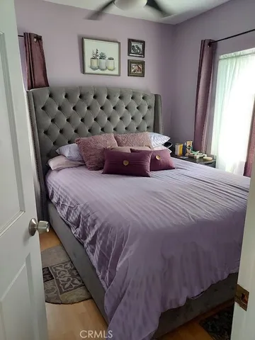 a bedroom with a bed and glass door