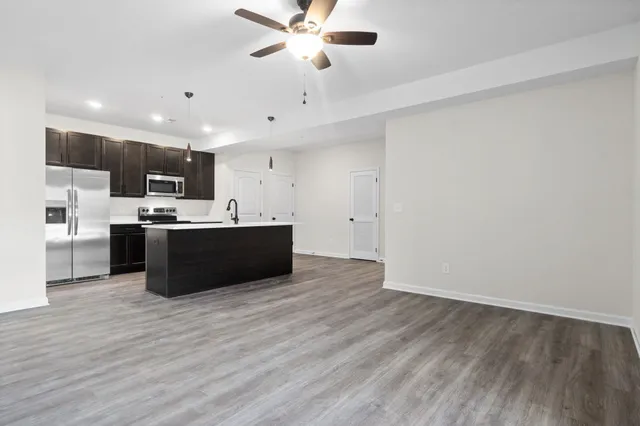 a kitchen with stainless steel appliances a refrigerator sink and microwave