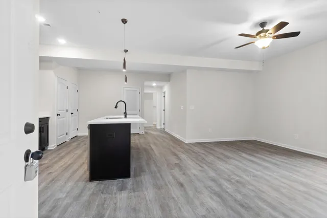 a view of a kitchen with sink and wooden floor