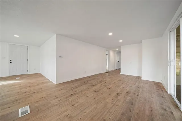 a view of an empty room and wooden floor