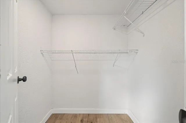 a view of hallway with wooden floor