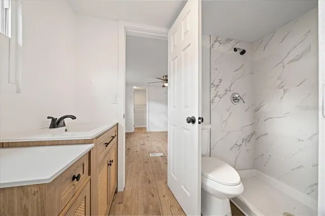 a view of hallway with wooden floor and door