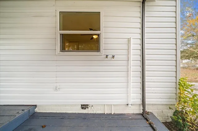 a view of a field with grass and trees