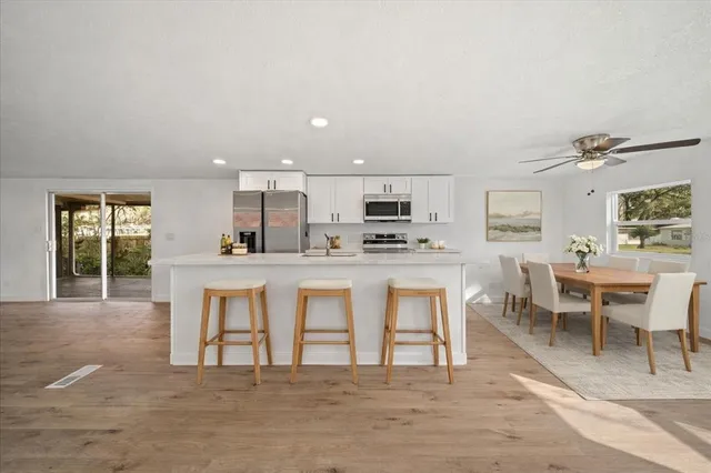 a view of a kitchen with a sink and a refrigerator