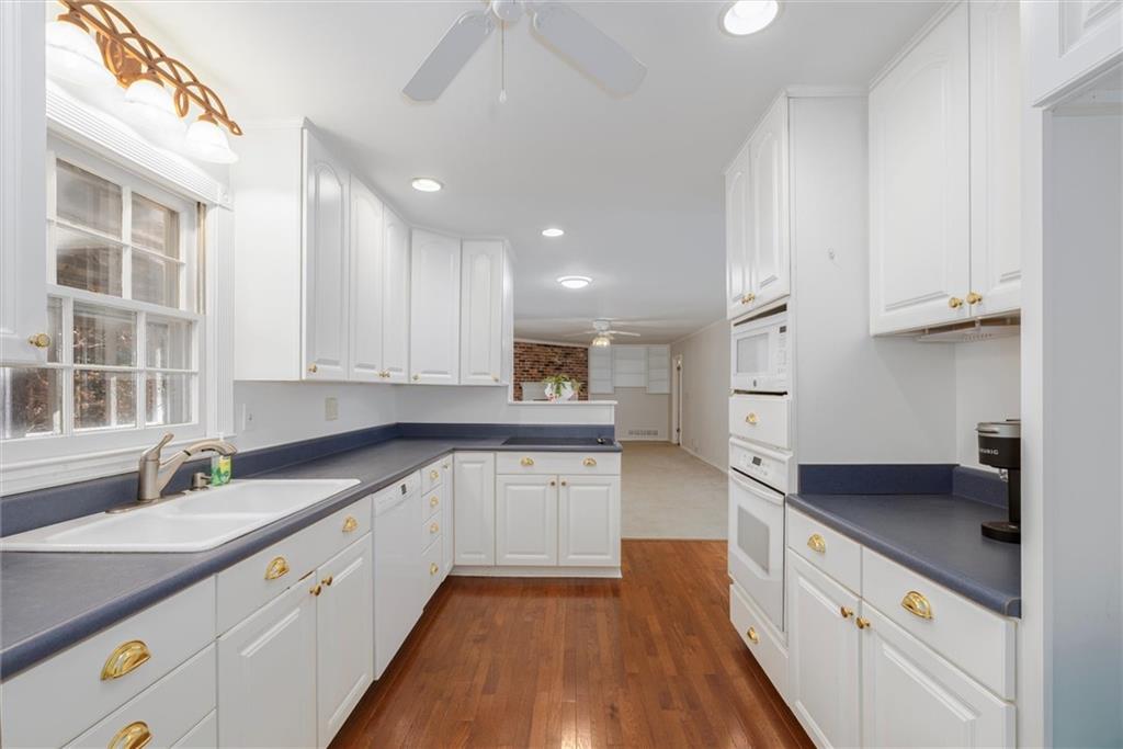2350 Oxbow Circle Smoke Rise, GA 30087 - Photo 15 of 51 a kitchen with granite countertop white cabinets and white appliances