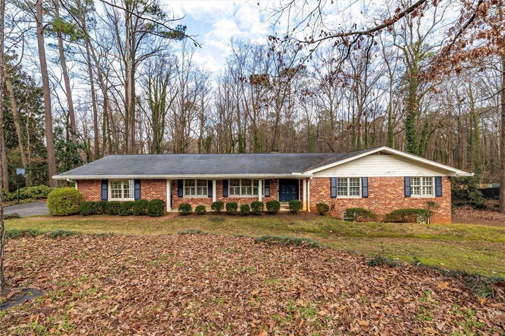 2350 Oxbow Circle Smoke Rise, GA 30087 - Photo 2 of 51 a front view of a house with a garden