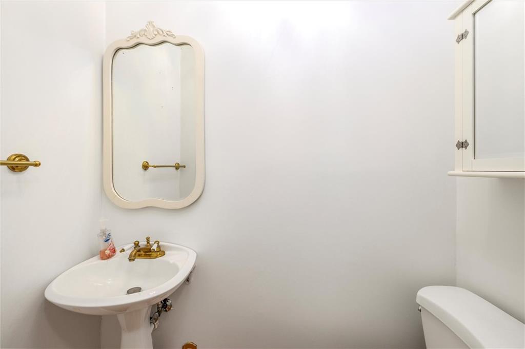 2350 Oxbow Circle Smoke Rise, GA 30087 - Photo 24 of 51 a bathroom with a sink a mirror and toilet