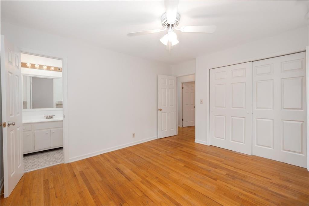 2350 Oxbow Circle Smoke Rise, GA 30087 - Photo 37 of 51 a bedroom with a bed and a chandelier