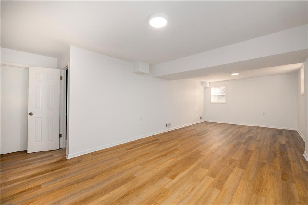2350 Oxbow Circle Smoke Rise, GA 30087 - Photo 39 of 51 an empty room with wooden floor and windows