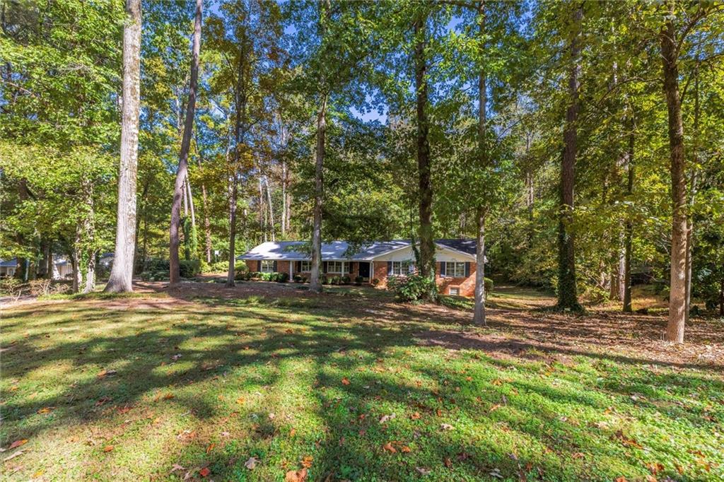 2350 Oxbow Circle Smoke Rise, GA 30087 - Photo 4 of 51 a front view of a house with a yard table and chairs