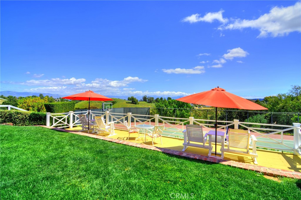 5360 Whitman Road Hidden Hills, CA 91302 - Photo 11 of 11 a view of a swimming pool with a table and chairs under an umbrella