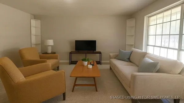 a living room with furniture a flat screen tv and a window