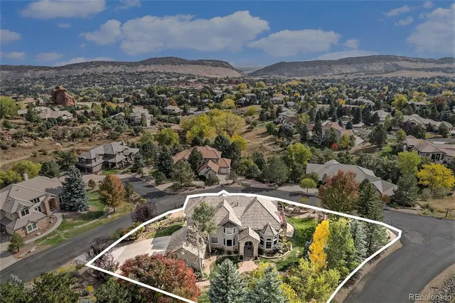 an aerial view of a house with a yard