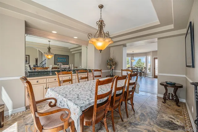 a living room with furniture a piano and a floor to ceiling window