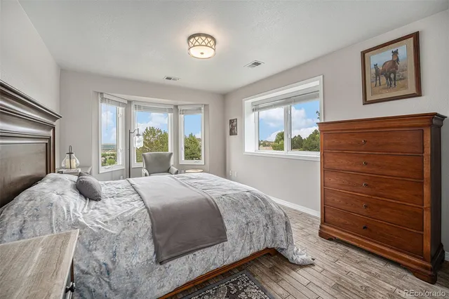 a living room with furniture kitchen view and a window