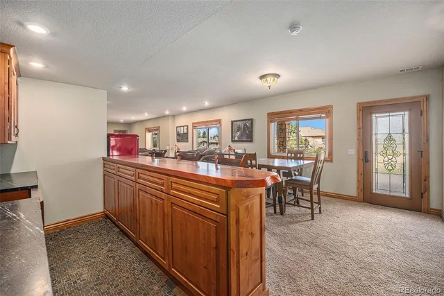 a bathroom with a granite countertop sink a toilet and shower