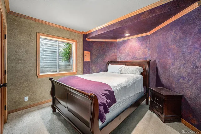 a bedroom with a bed and a fireplace