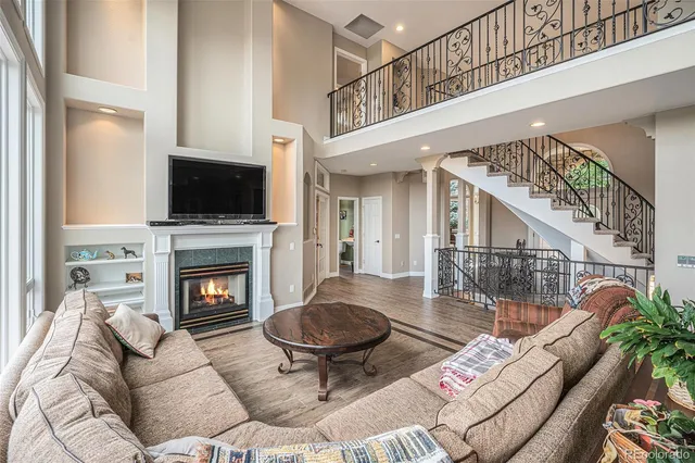 a living room with furniture a piano and a floor to ceiling window