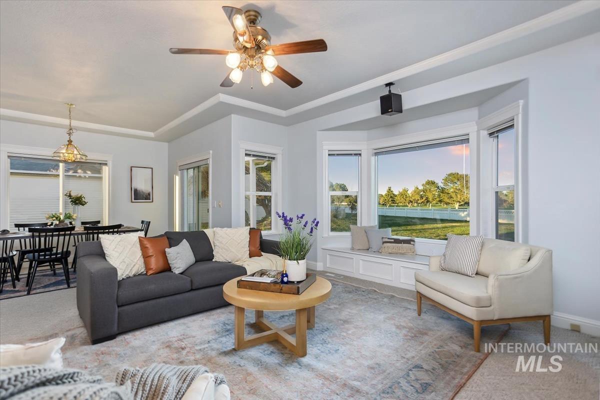 25074 The Driving Lane Caldwell, ID 83607 - Photo 11 of 32 Living area featuring carpet and a ceiling fan