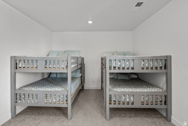 1122 South 1790th West, Unit 1 St. George, UT 84770 - Photo 22 of 37 Bedroom featuring two wooden bunk beds with gray frames, white walls, recessed lighting, and carpeted flooring