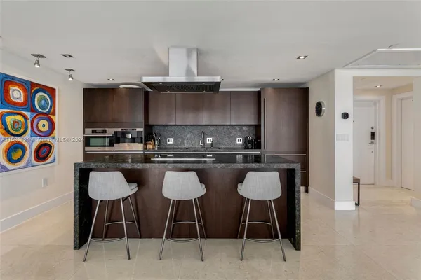 a kitchen with a table chairs stove and cabinets