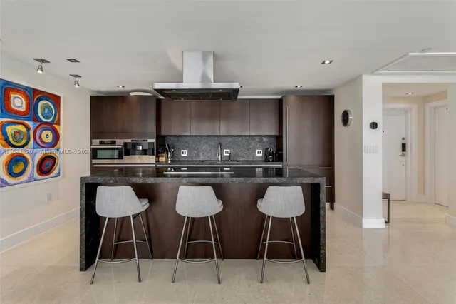 a kitchen with a table chairs stove and cabinets