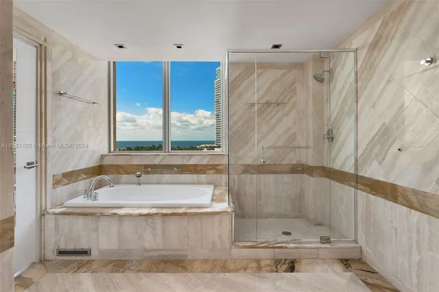 a spacious bathroom with a granite countertop tub sink and mirror