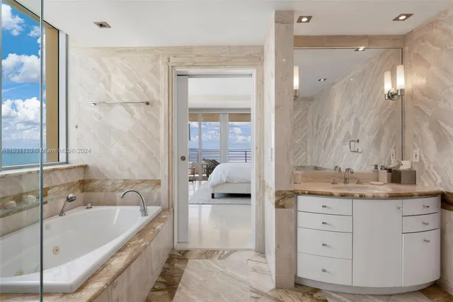 a bedroom with a large bed and a large window